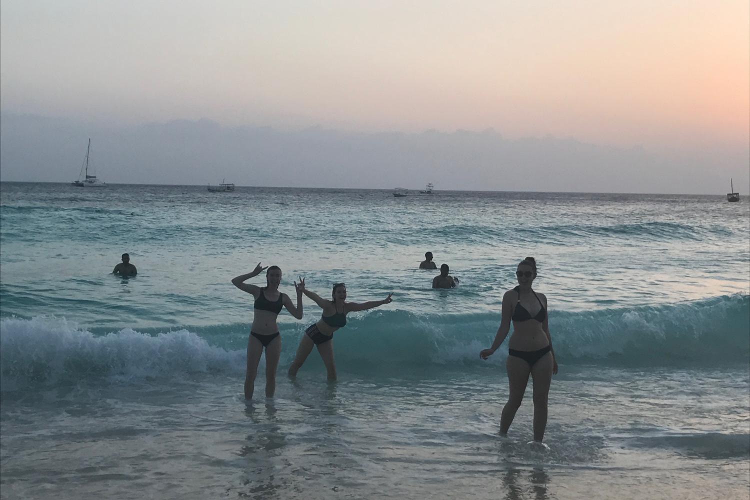 Students pose on the ocean front.